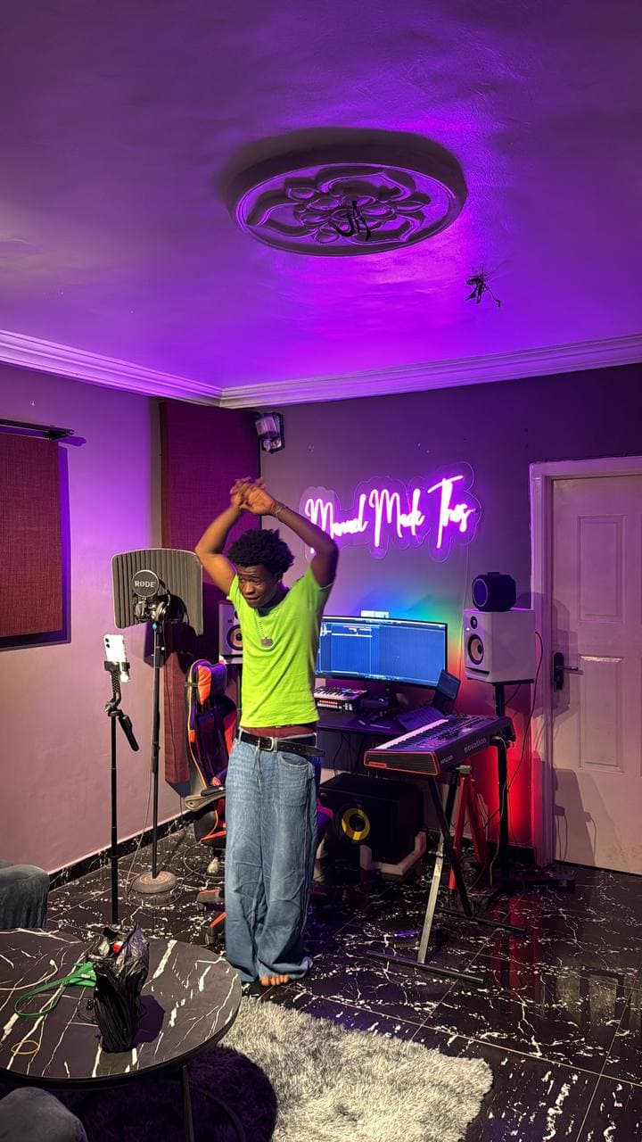 An artist dancing with their arms up beside the mic