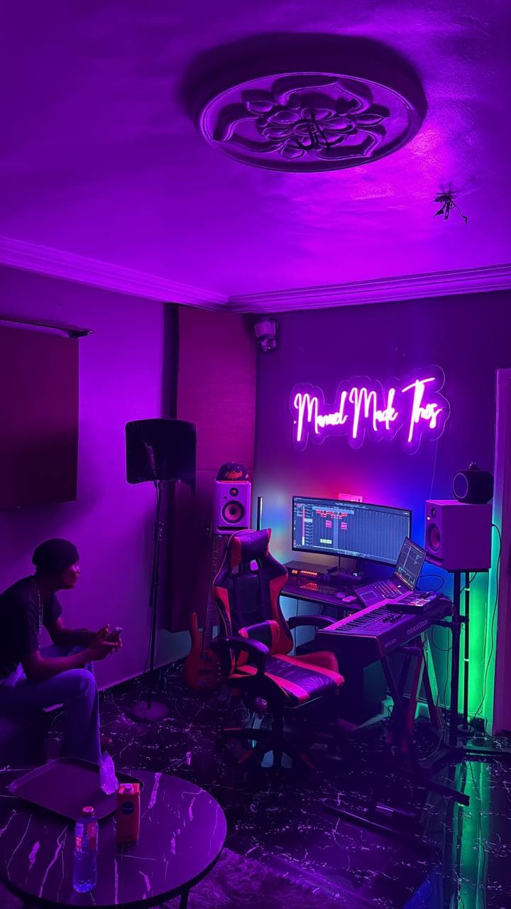 The producer at the desk while someone relaxes in the lounge