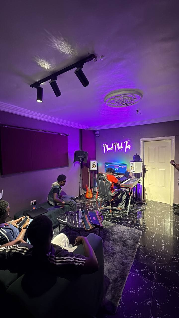 Artists relaxing on the sofa while a session runs at the desk
